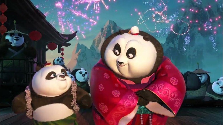 Mei Mei and Bao walking together with fireworks in the sky in Panda Paws