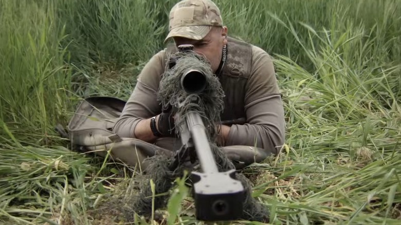 Man aiming sniper rifle