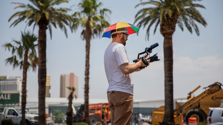 John Wilson umbrella hat filming