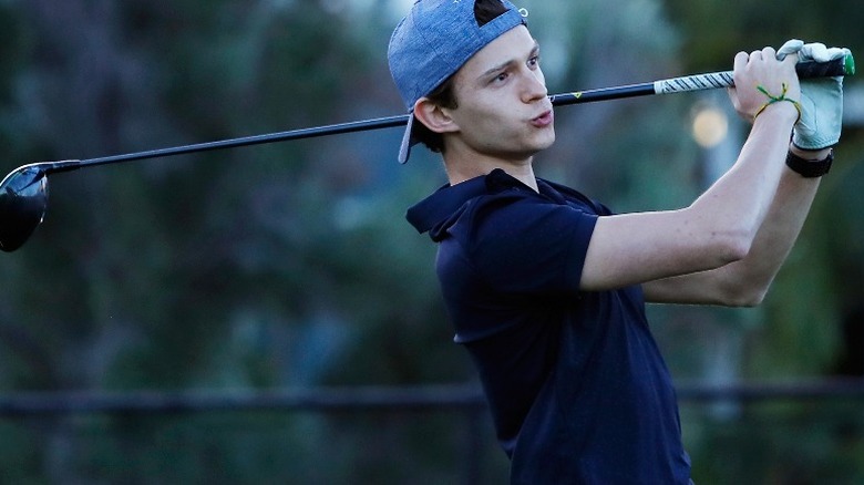 Tom Holland golfing