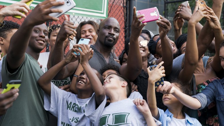 Luke surrounded by fans in season 2 of Netflix's Luke Cage series