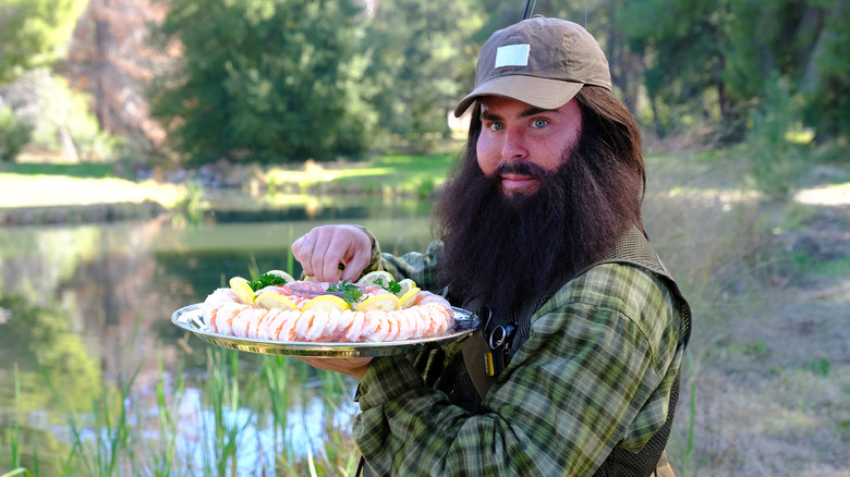 Bearded Zac Efron holding shrimp