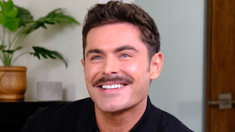 Zac Efron smiling with moustache