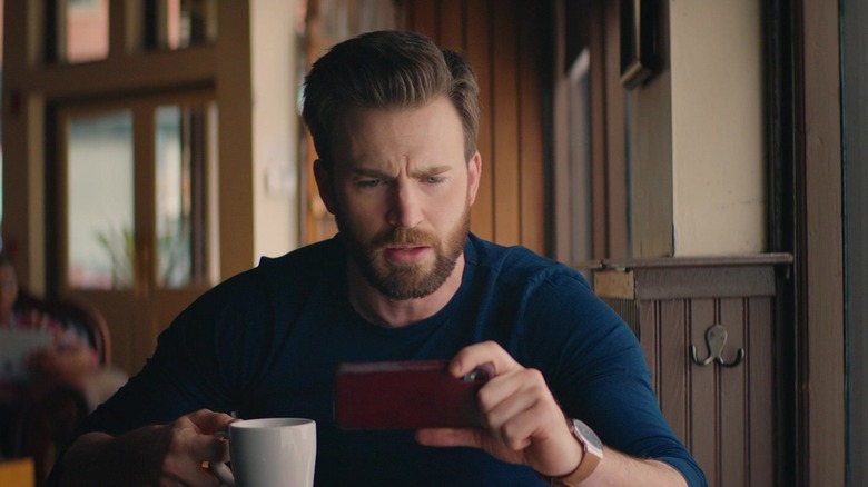 Chris Evans holding phone