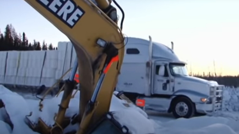 Hugh Rowland drives a truck past a stuck piece of equipment