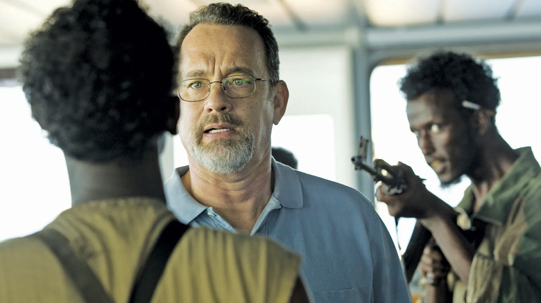 Captain Phillips is confronted by pirates 