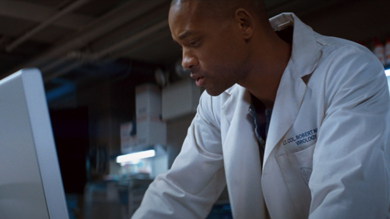 Robert Neville in lab coat looking at computer