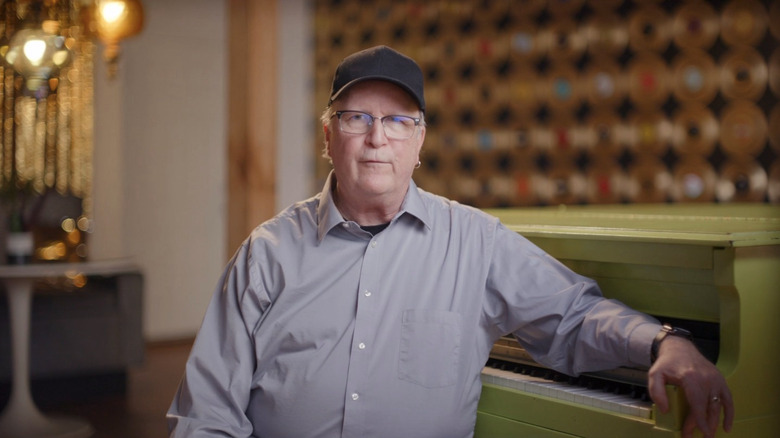 Bob Singleton sitting by piano