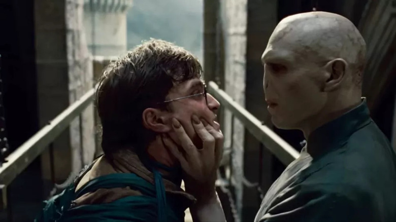 Voldemort clutching Harry's face on a bridge