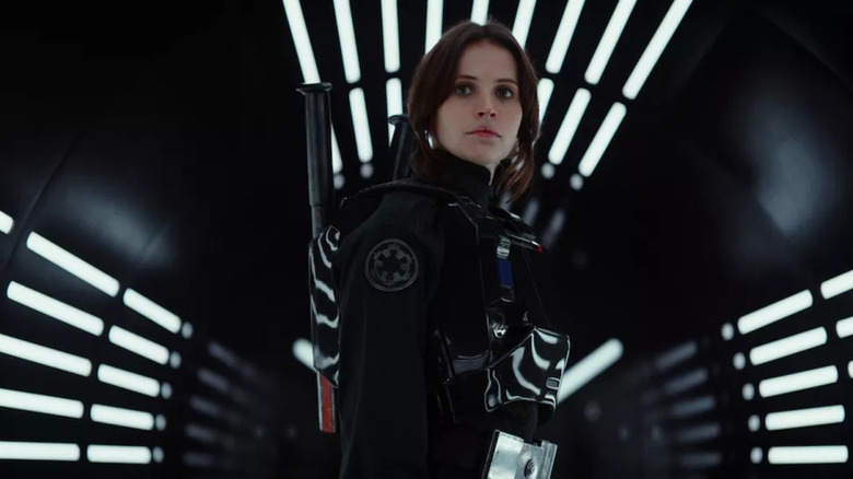 Jyn standing in a light-up corridor