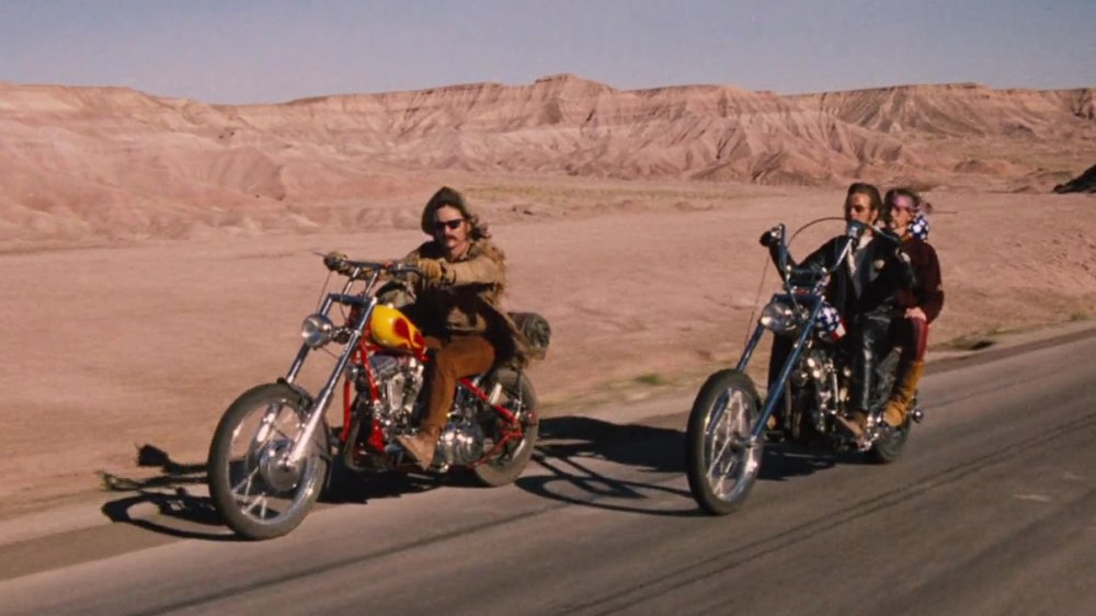 Two motorcycles with three bikers in a scene from Easy Rider