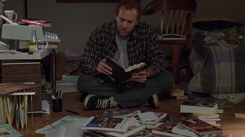 Charlie reading books on floor