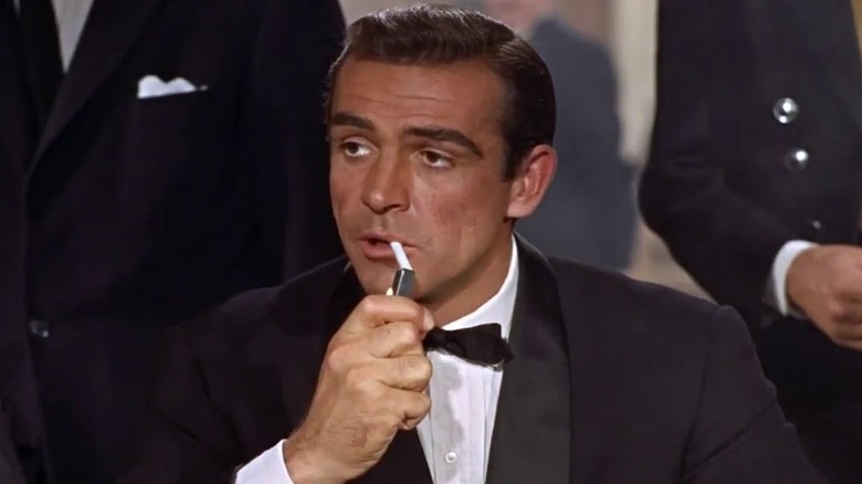 James Bond lights his cigarette