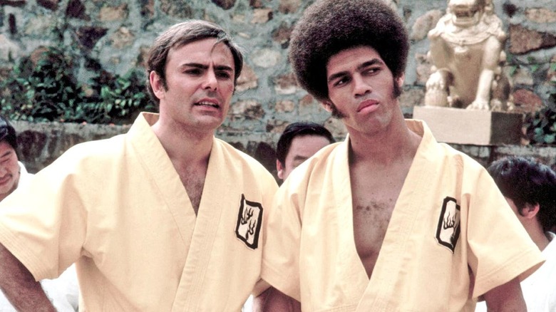 Williams and Roper in yellow robes Enter the Dragon