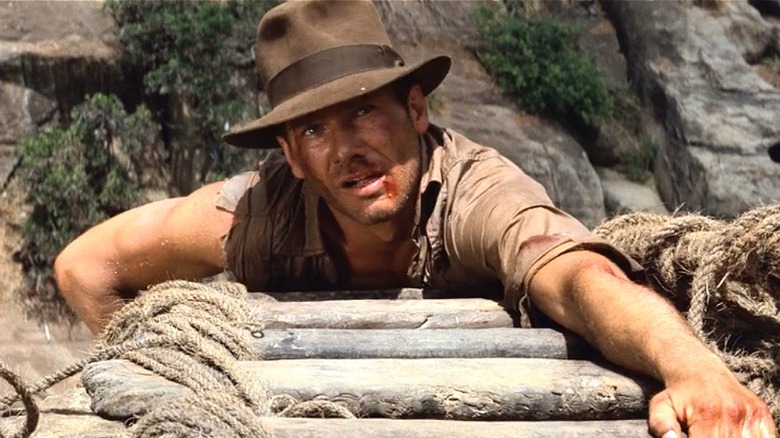 Indiana Jones climbes up bridge