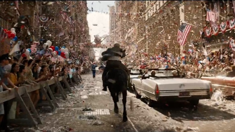 Indiana Jones riding a horse through a parade