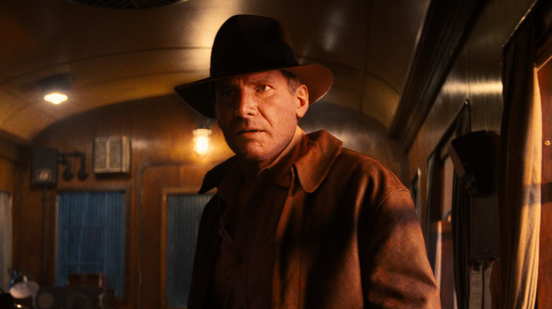 Indiana Jones looking confused while standing on a train