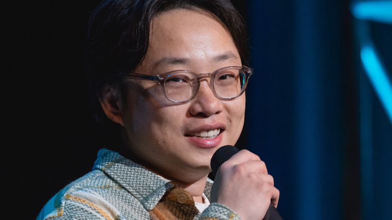 Jimmy O. Yang holding a microphone