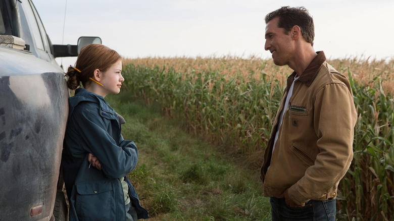 Mackenzie Foy crossing her arms in front of Matthew McConaughey