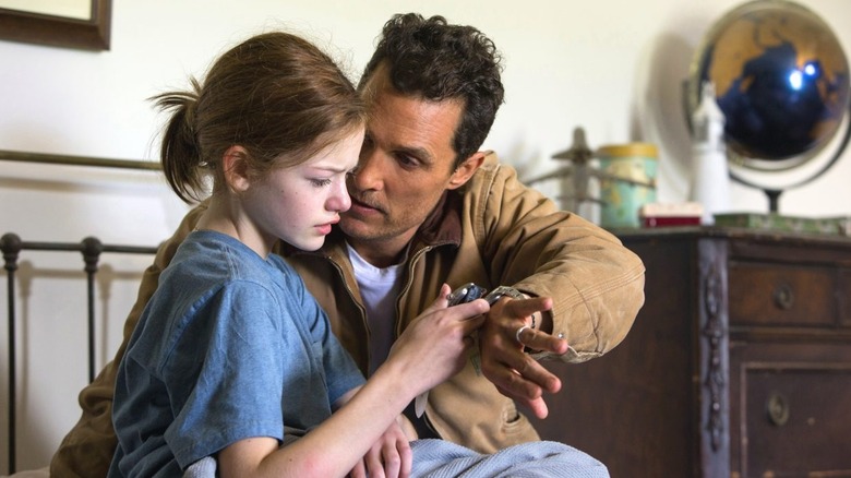 Mackenzie Foy and Matthew McConaughey looking at watches