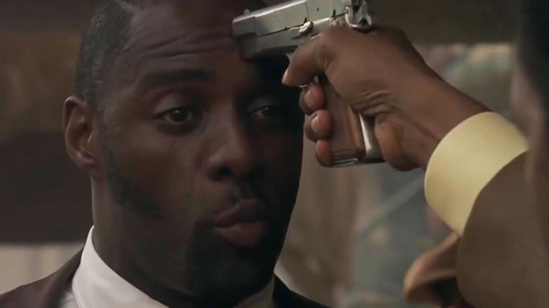 Idris Elba with a gun to his head