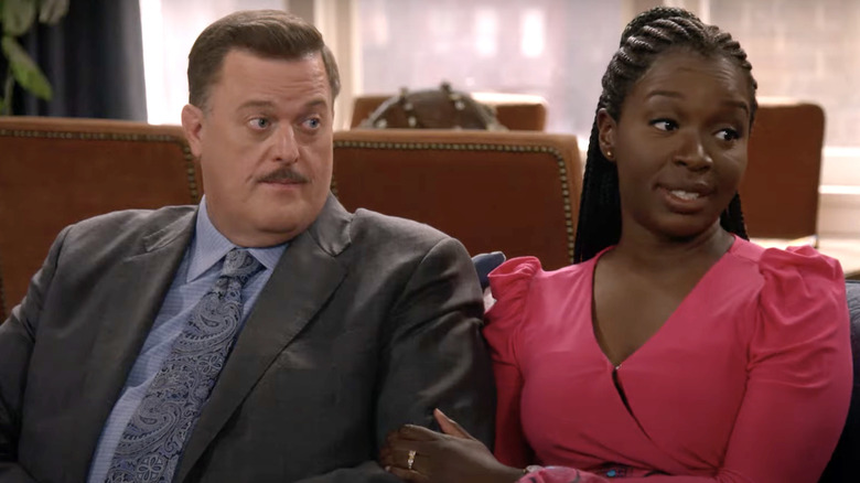 Billy Gardell,  Folake Olowofoyeku sitting on couch together