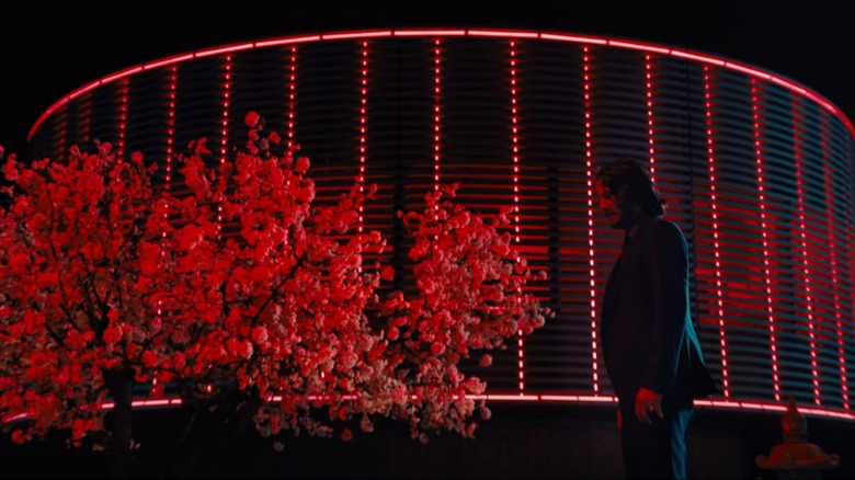 John Wick at a red tree