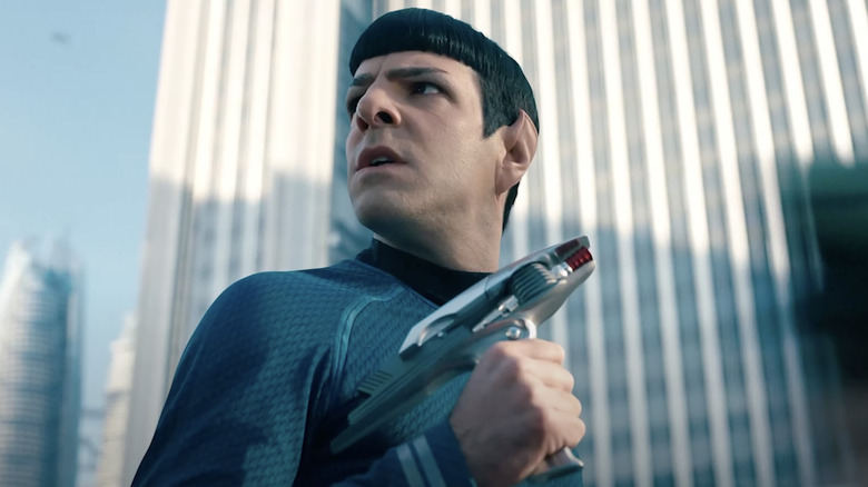 Spock holding gun in city streets