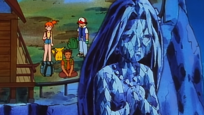 Ash's group watching statue