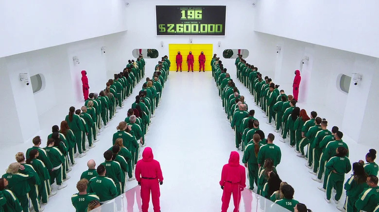 Contestants in lines green tracksuits