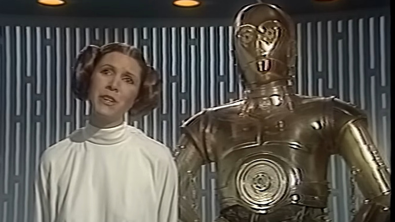 Leia and C-3PO standing together