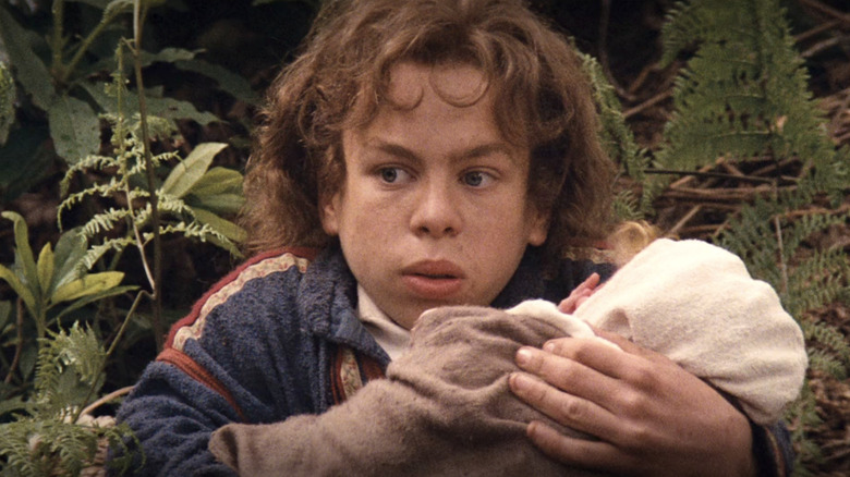 Warwick Davis holding baby Willow