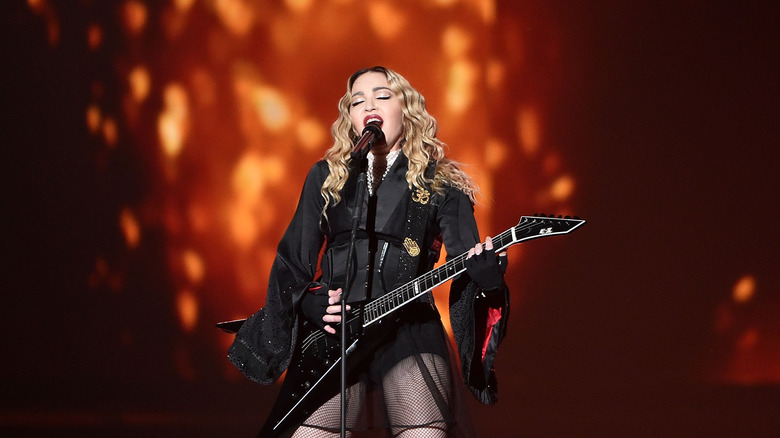 Madonna playing guitar on stage