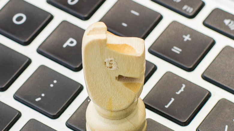 A knight chess piece on a keyboard