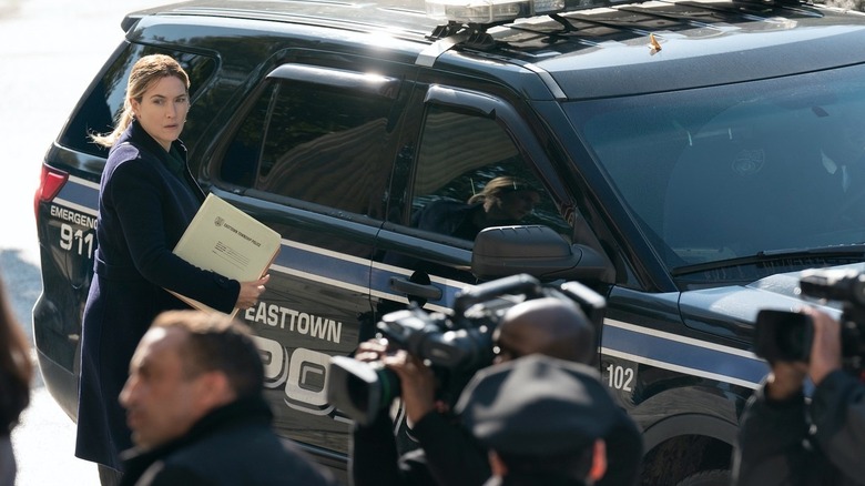 Kate Winslet outside a police vehicle in "Mare of Easttown"