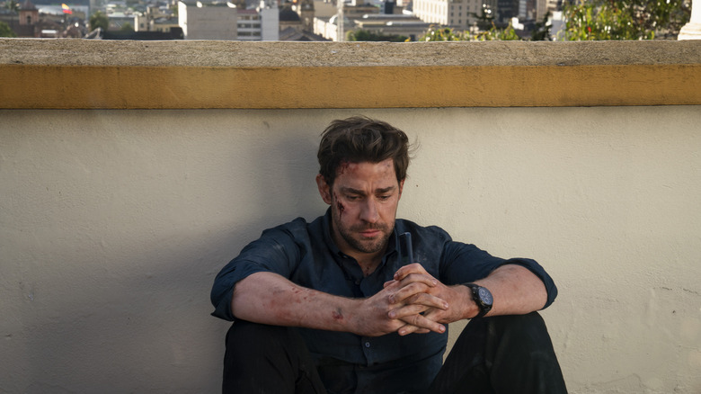 Jack Ryan sitting on the ground sad