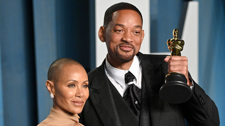 Will Smith and Jada Pinkett Smith posing with award