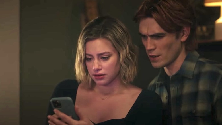 Lili Reinhart as Betty and K.J. Apa as Archie looking scared on Riverdale