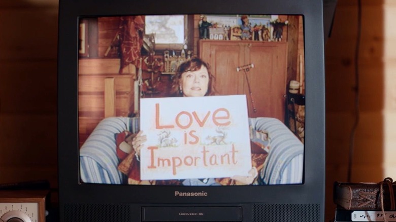 Honey holding "love is important" sign