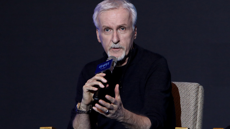 James Cameron speaking into a microphone