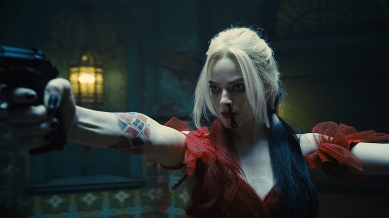 Margot Robbie as Harley Quinn in red dress with bloody nose in The Suicide Squad