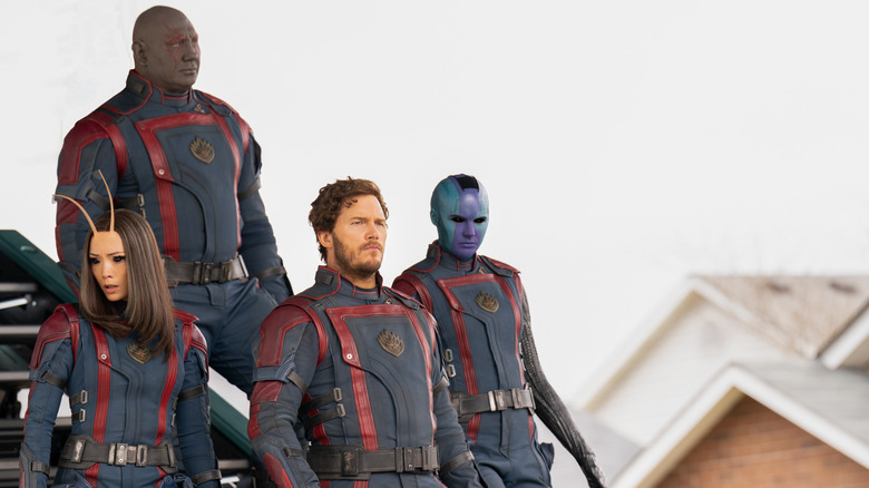 Mantis, Drax, Peter Quill, and Nebula walking in matching suits