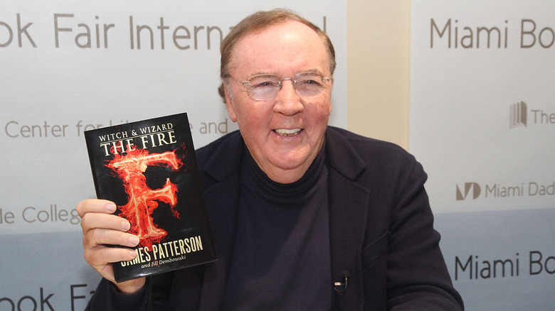 James Patterson holding one of his books