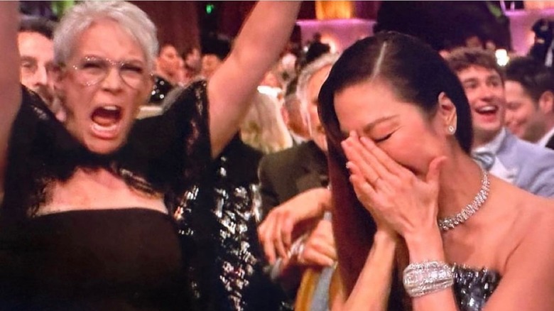 Jaimiee Lee Curtis wearing black dress cheering for Michelle Yeoh