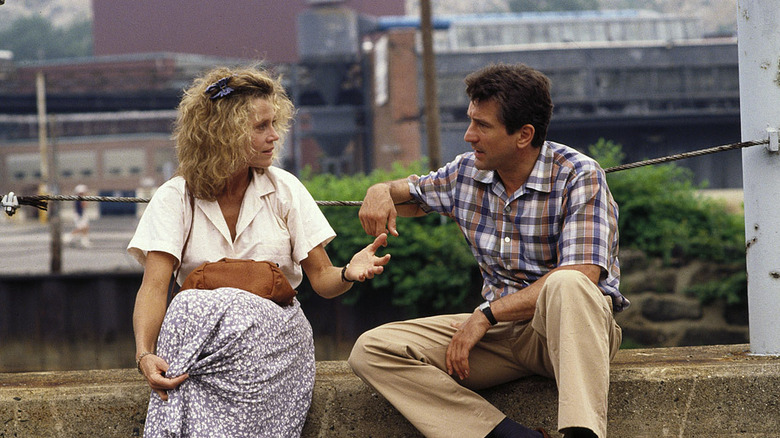 Jane Fonda sits on a curb