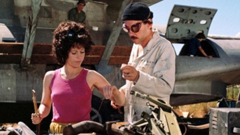 Jane Fonda repairs a car