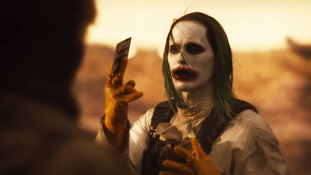 The Joker holding a joker card