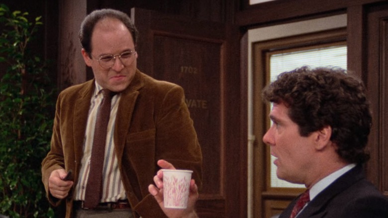 George standing at conference table