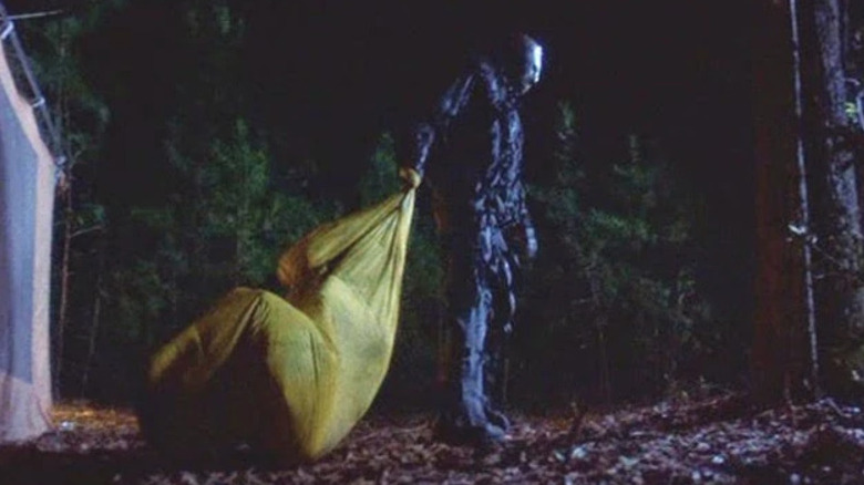 Jason prepares to swing Judith in a sleeping bag