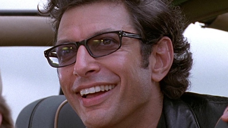 Dr. Ian Malcolm looking out of a vehicle in Jurassic Park